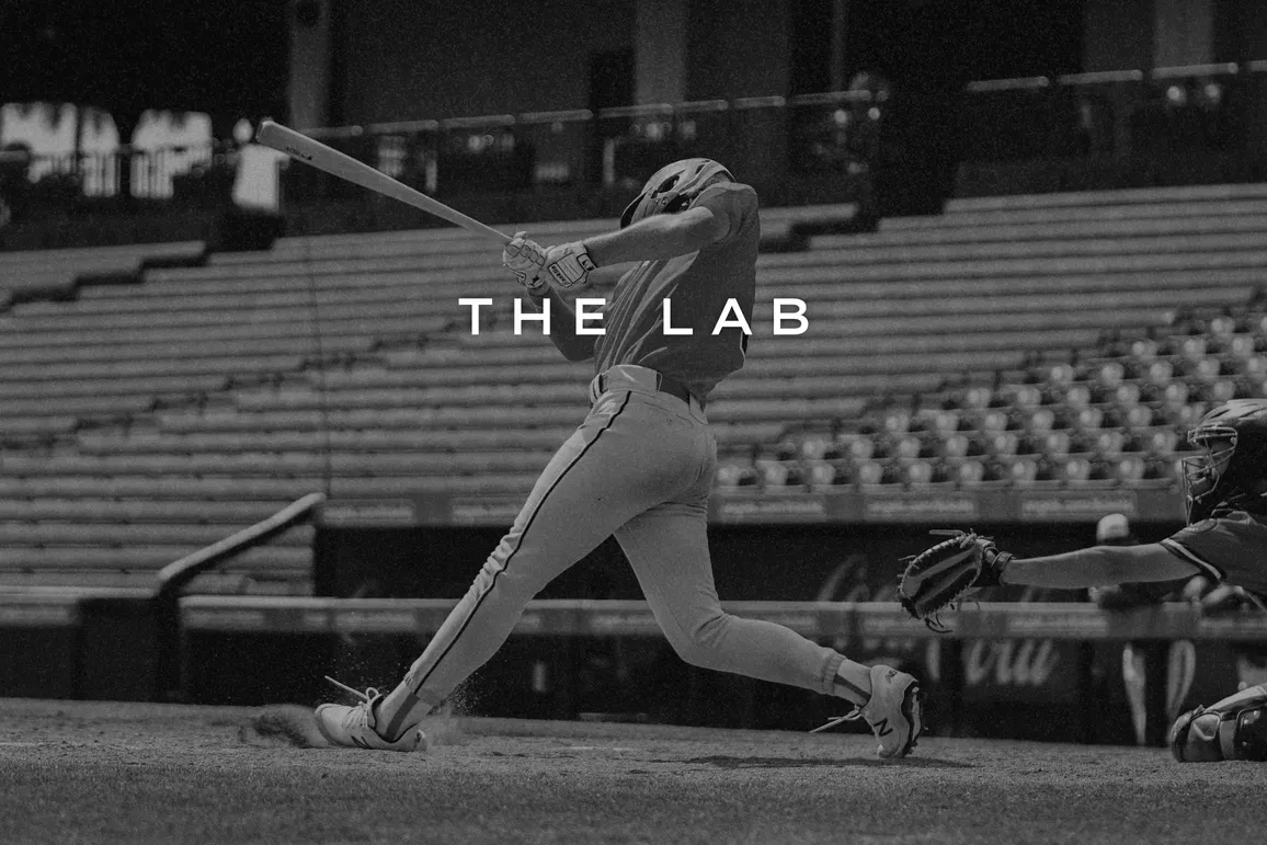 A baseball player swings at a pitch.