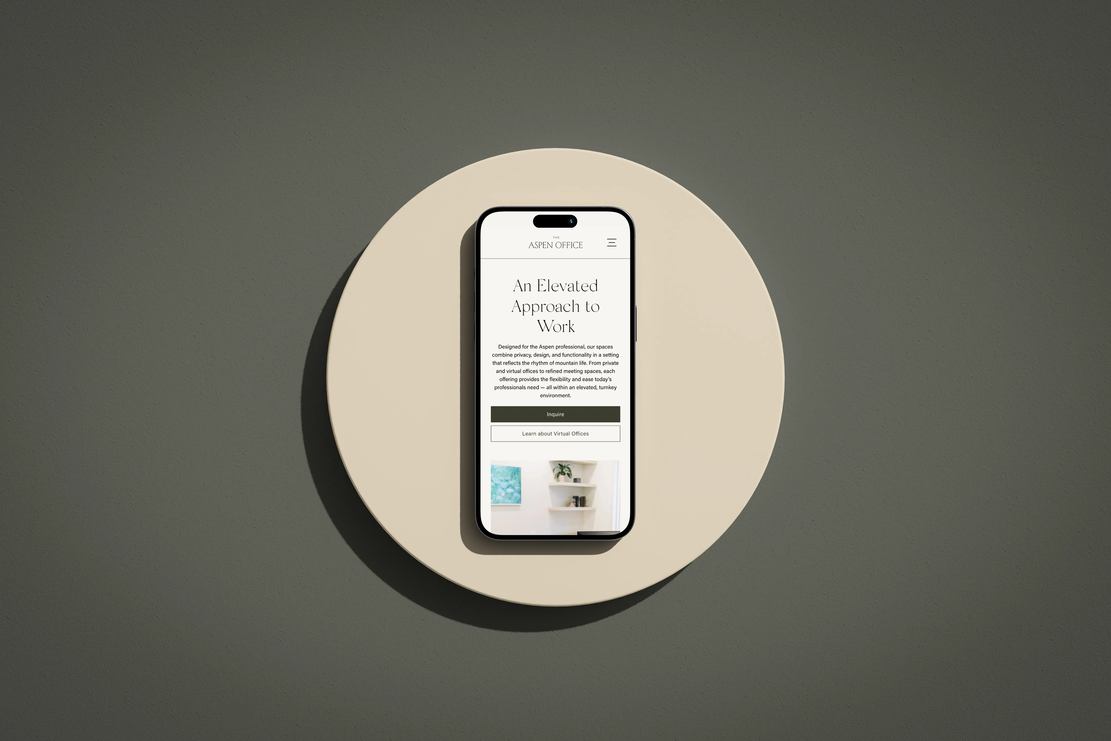 A mobile phone laying on stop of a circular pedestal, showing the Offerings page of The Aspen Office.